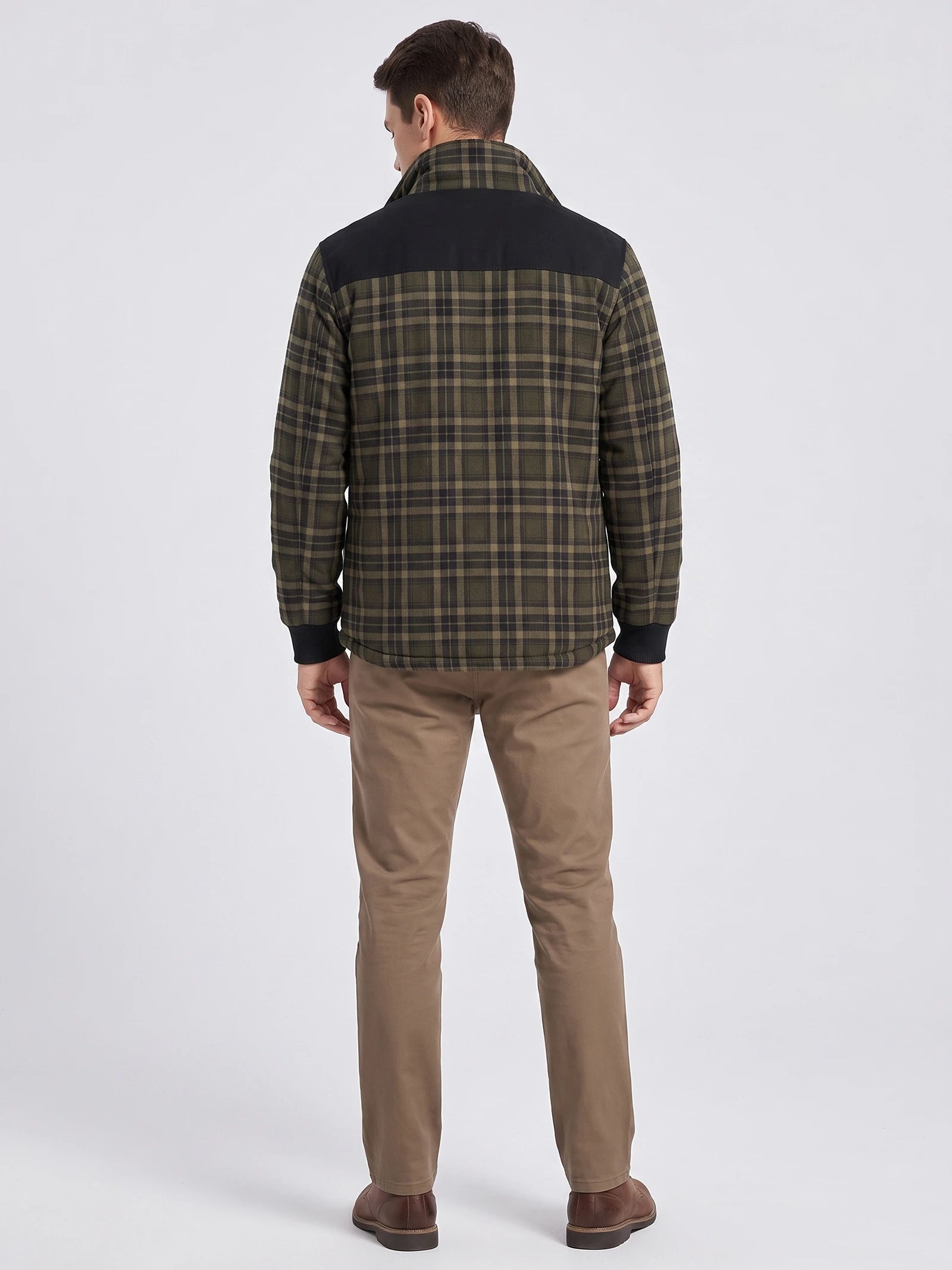 Rear studio view of a model wearing a Green plaid Fleece Lined shirt jacket with a contrast shoulder panel.
