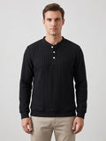 Front studio view of a model wearing a Black fleece lined sweater with ribbed texture, long sleeves, and a three-button Henley placket.