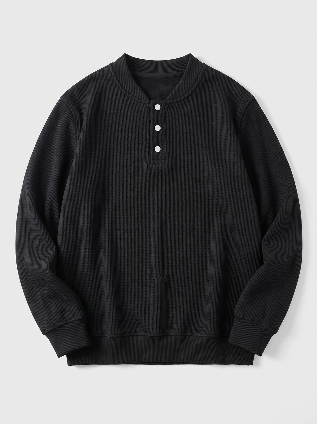Black fleece lined sweater laid flat, featuring a ribbed shawl collar, three-button placket, and long sleeves.