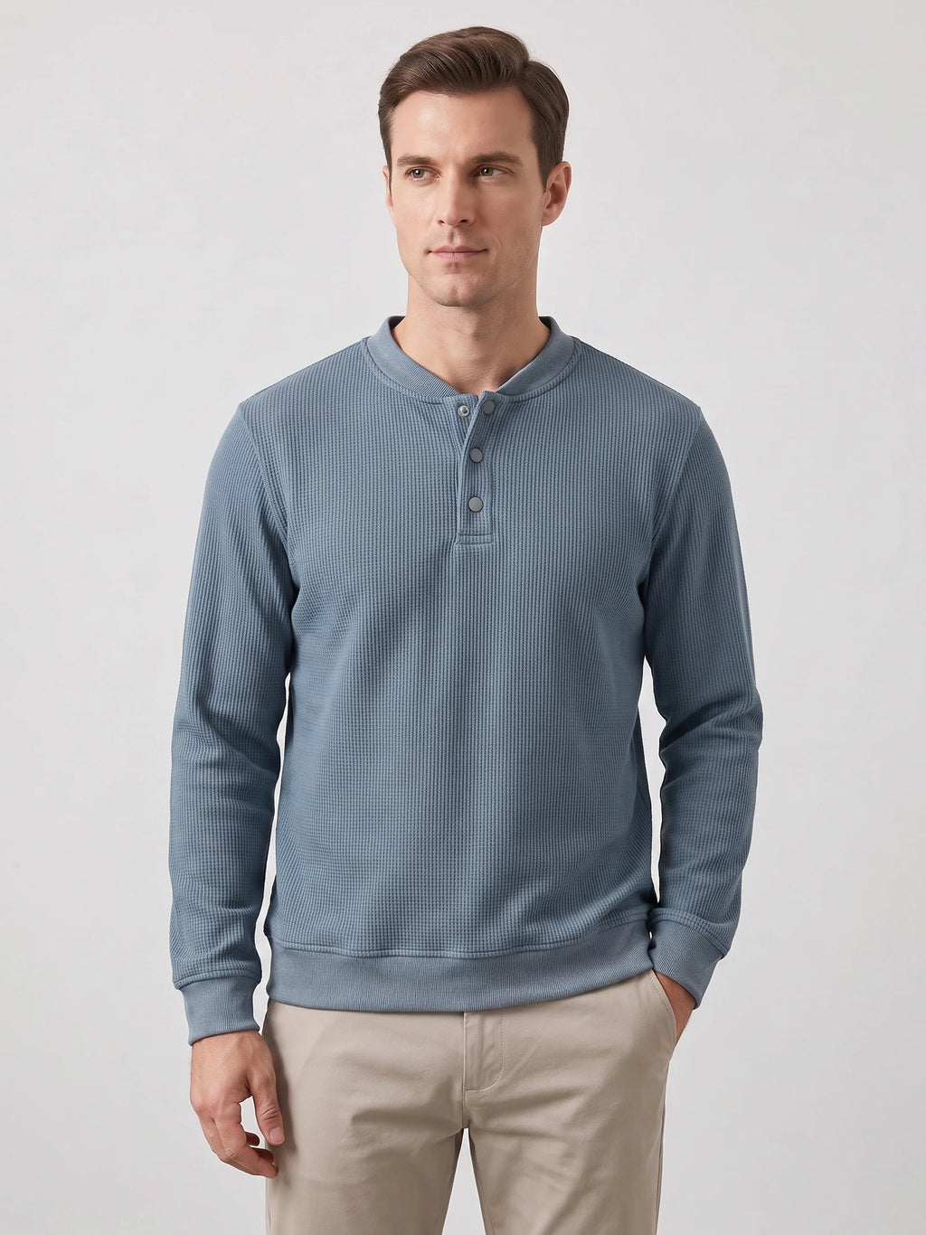 Front studio view of a model wearing a Blue fleece lined sweater with a ribbed knit texture and three-button Henley placket.