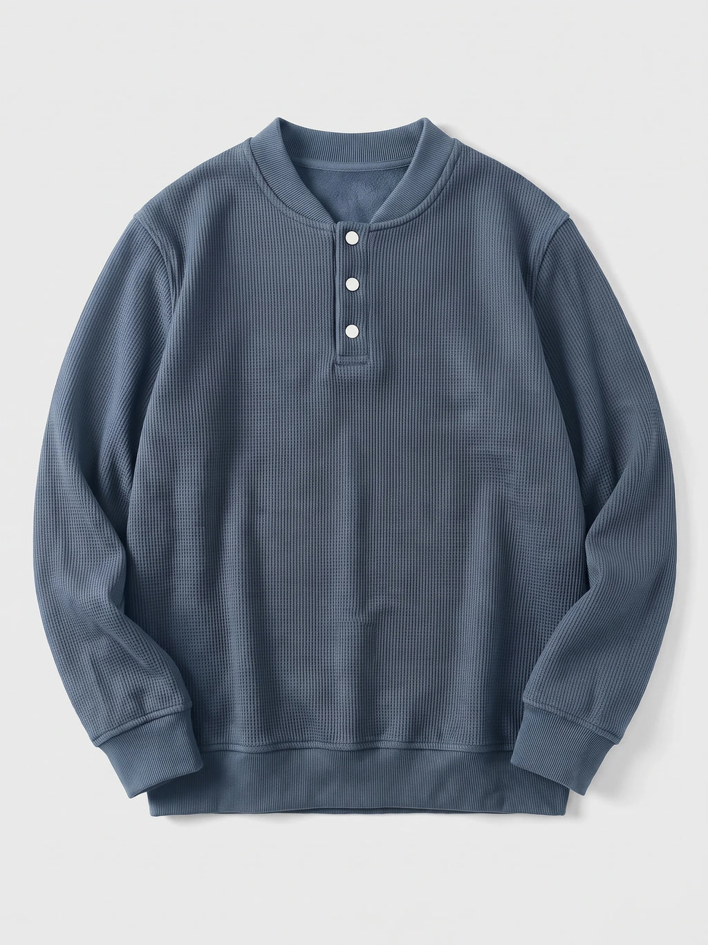 Blue fleece lined sweater laid flat, featuring a three-button Henley placket, textured knit body, and ribbed cuffs and hem.