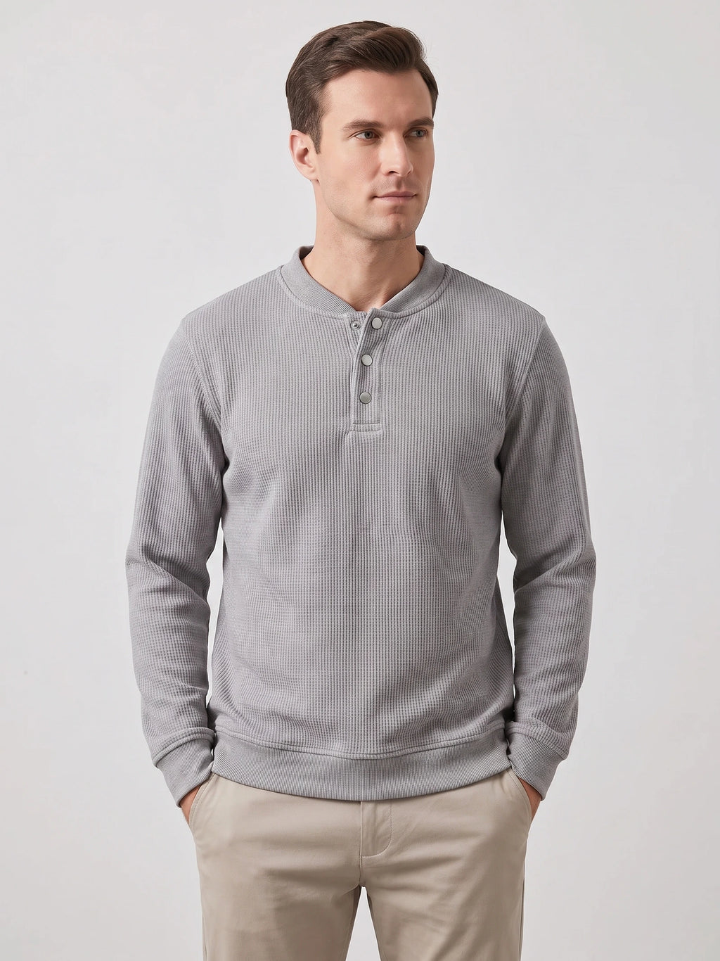 Model wearing a Gray fleece lined sweater with long sleeves, ribbed trim, and a three-button Henley placket in a front studio view.