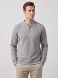 Model wearing a Gray fleece lined sweater with long sleeves, ribbed trim, and a three-button Henley placket in a front studio view.