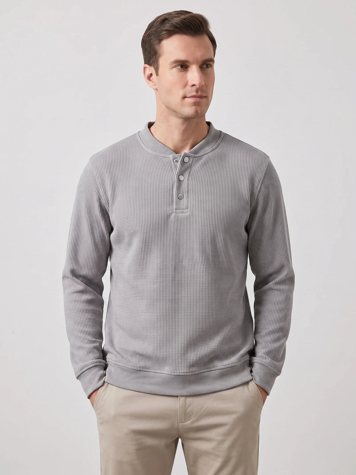 Model wearing a Gray fleece lined sweater with long sleeves, ribbed trim, and a three-button Henley placket in a front studio view.