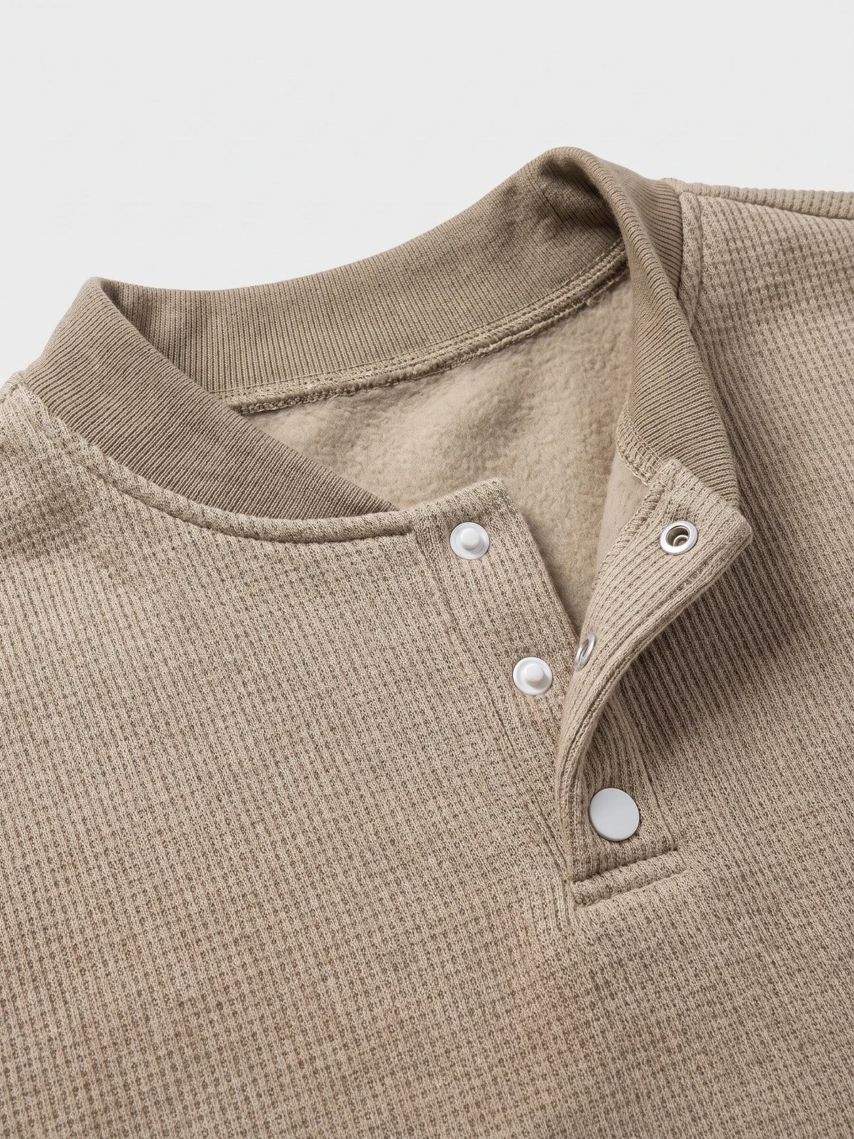 Khaki fleece lined sweater close-up showing the ribbed collar, snap-button Henley placket, and soft interior lining.