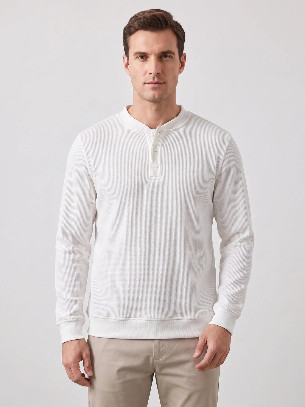 Front studio view of a model wearing a White fleece lined sweater with a three-button Henley placket and ribbed cuffs.