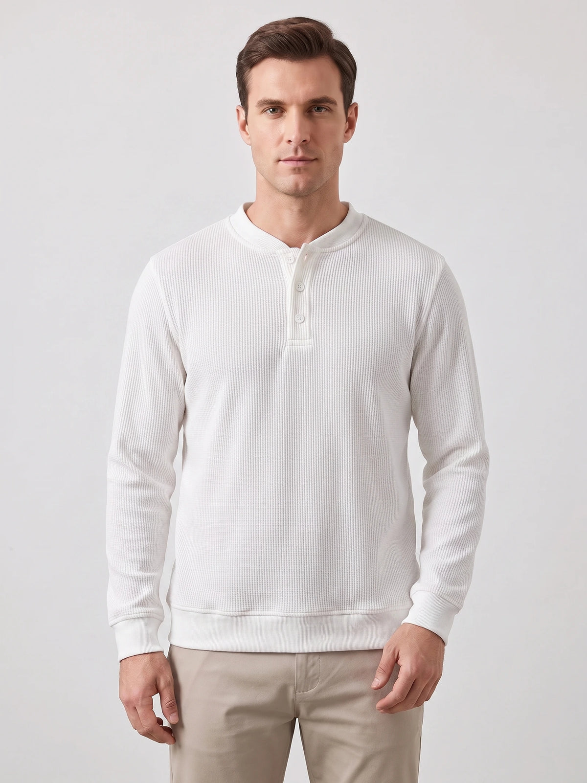 Front studio view of a model wearing a White fleece lined sweater with a three-button Henley placket and ribbed cuffs.