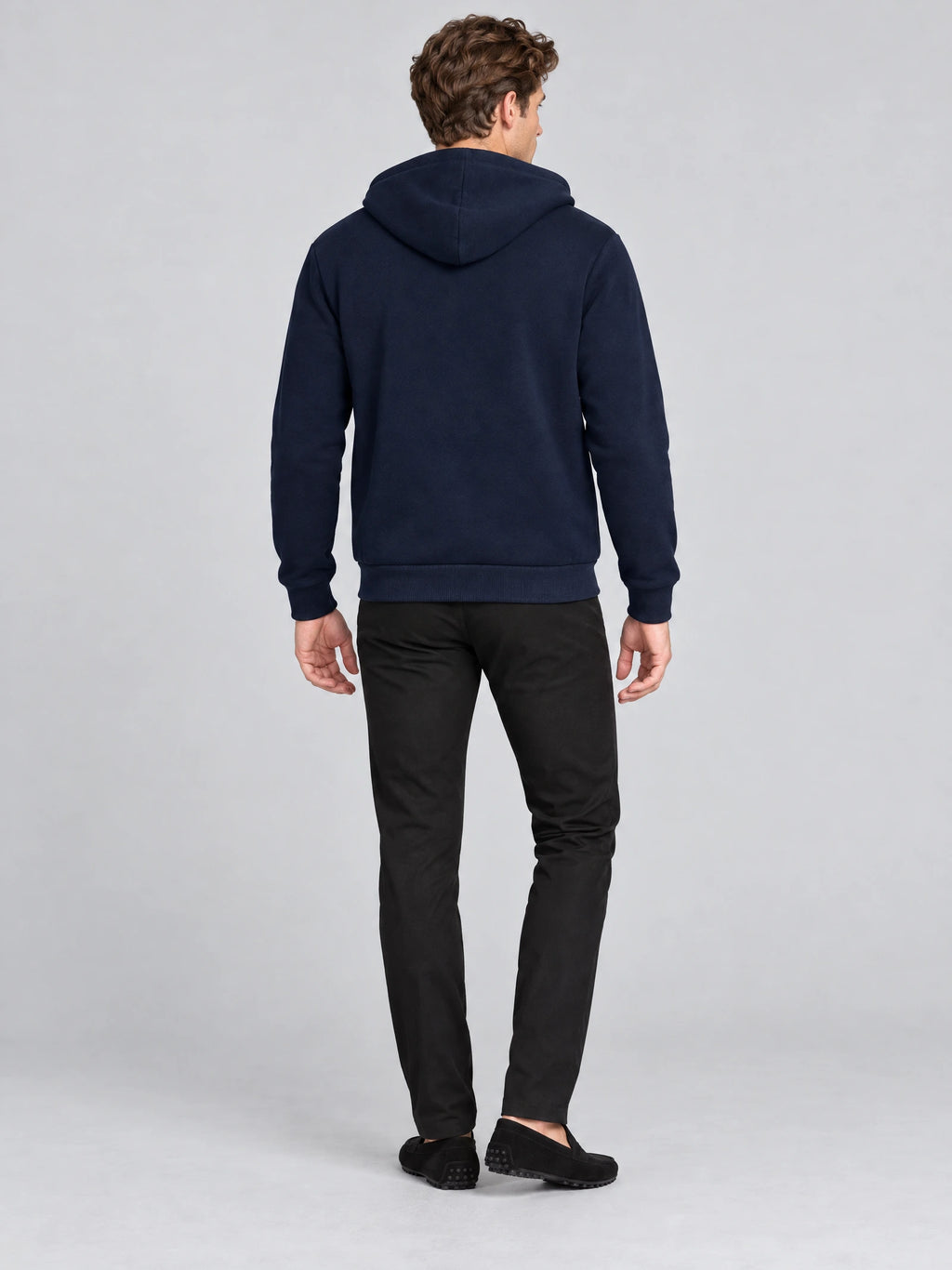 Rear studio view of a model wearing a Navy fleece-lined winter jacket with a hood and ribbed cuffs and hem.