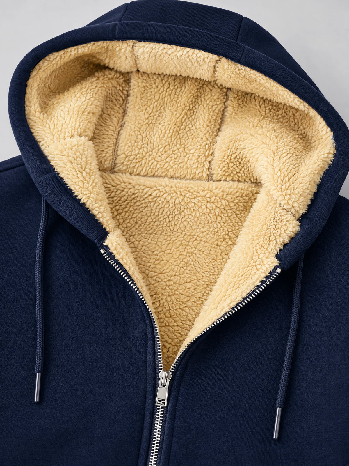 Close-up of the Navy fleece-lined winter jacket hood, showing plush lining, drawstrings, and zipper closure.