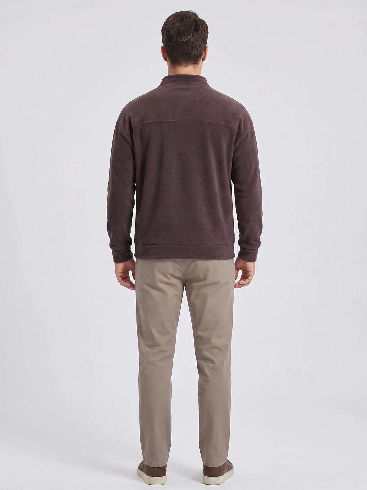Rear studio view of a model wearing a Brown men's Fleece Sweater with a mock neck, ribbed cuffs and hem, and a back yoke seam.