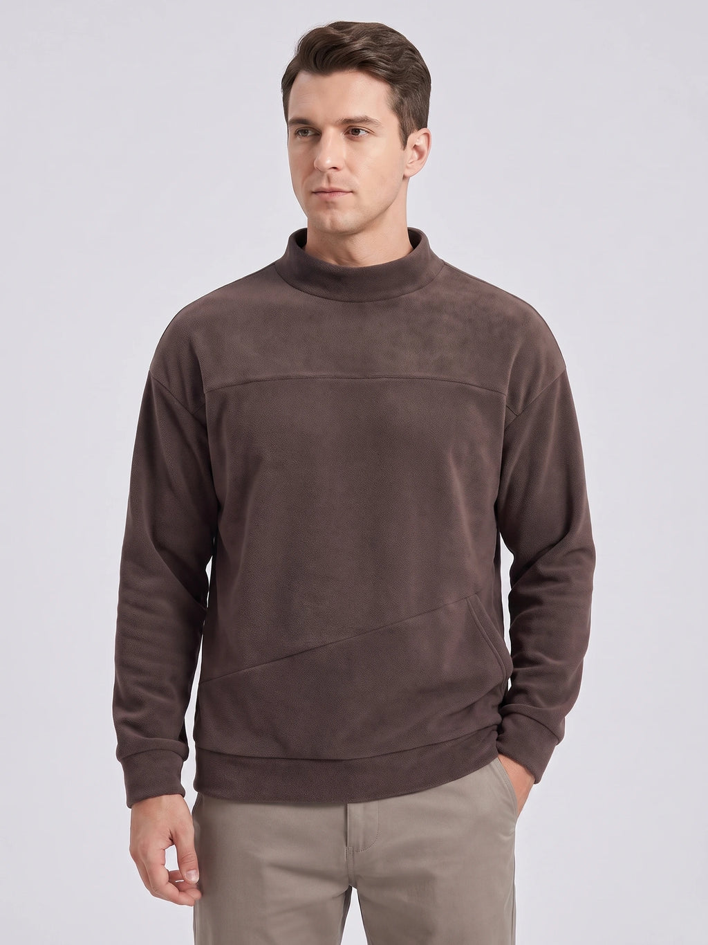 Front studio view of a model wearing a Brown men's Fleece Sweater with a mock neck and angled front pocket.