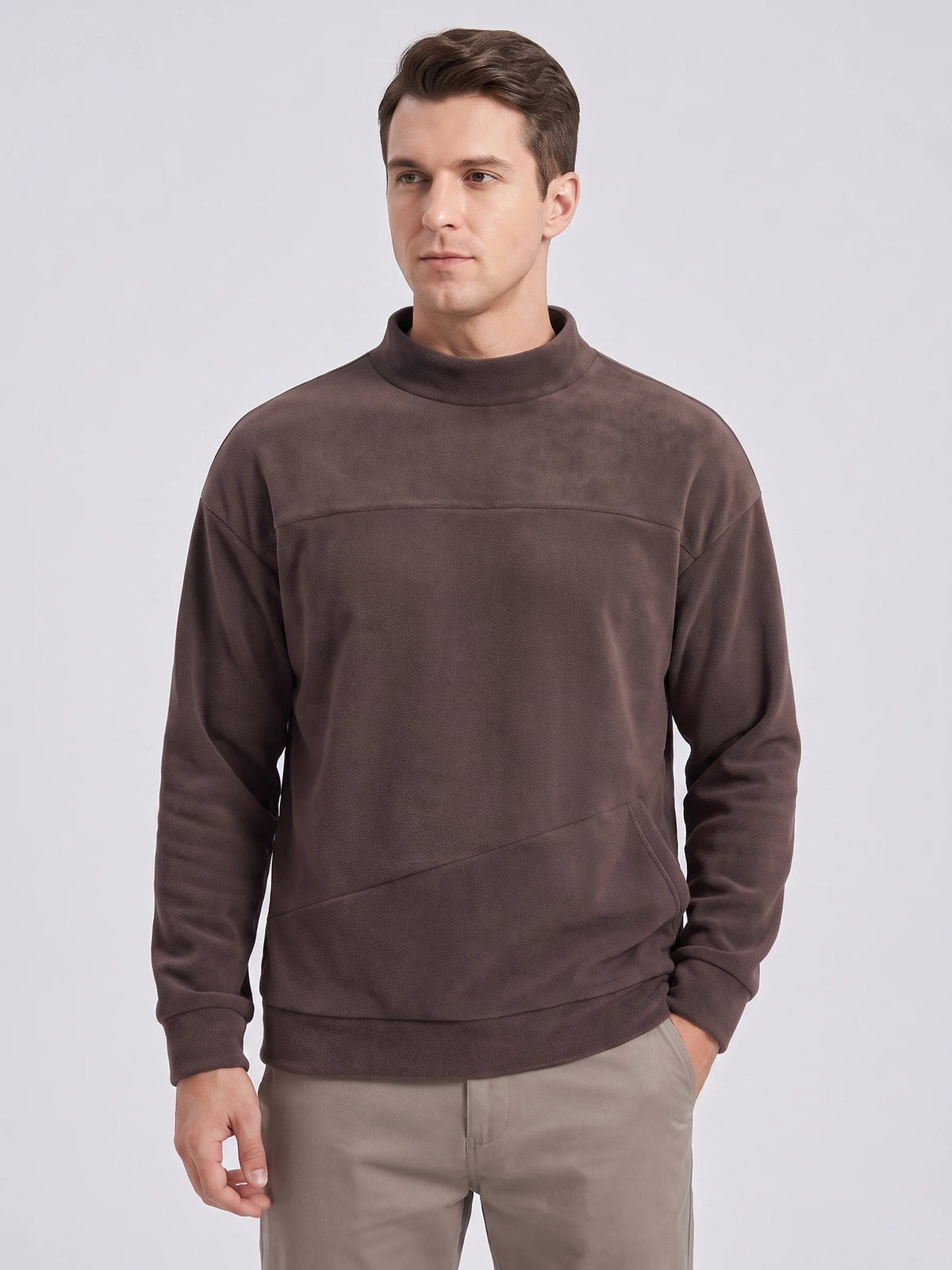 Front studio view of a model wearing a Brown men's Fleece Sweater with a mock neck and angled front pocket.