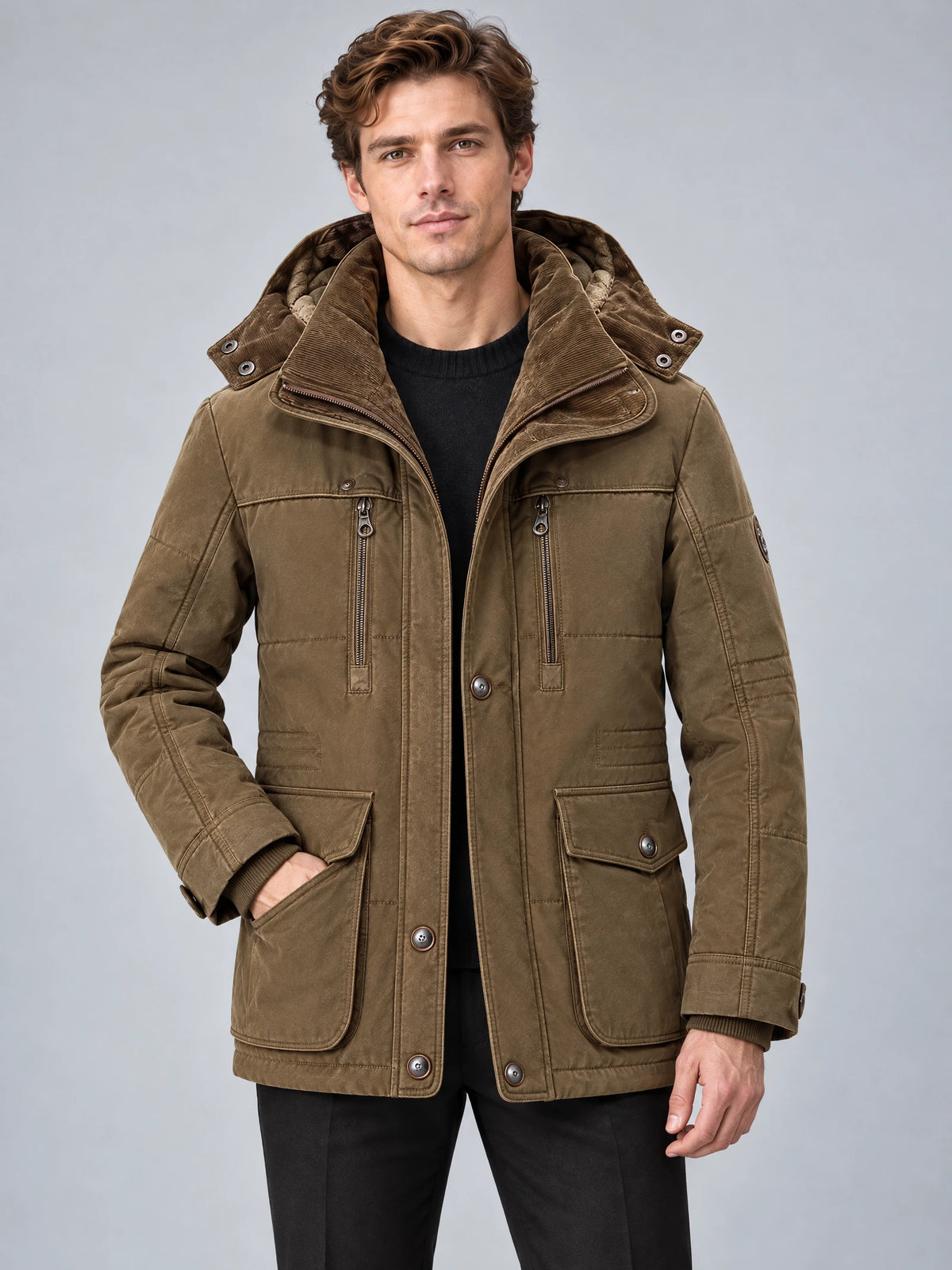 Front studio view of a model wearing a Brown heavy winter jacket with a padded hood, zip chest pockets, and flap front pockets.