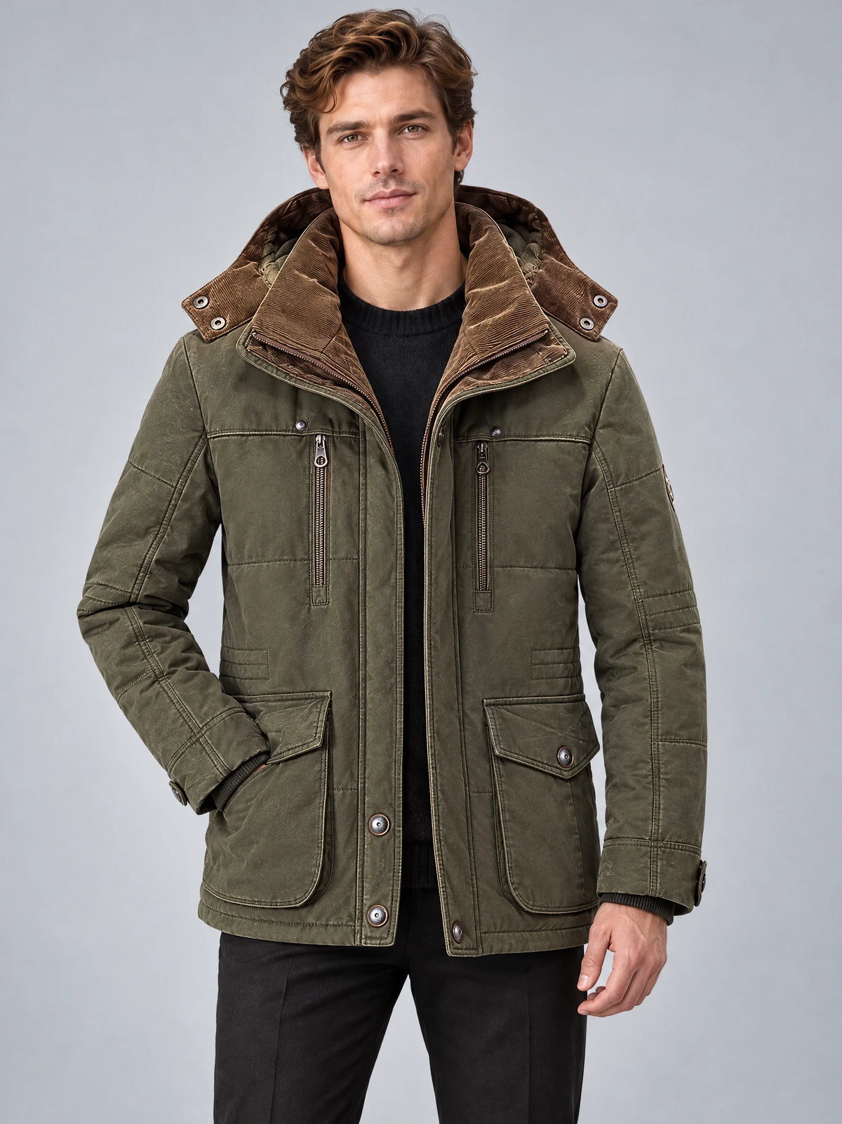 Front studio view of a model wearing a Green Heavy Winter Jacket with a hood, zip chest pockets, and buttoned flap pockets.