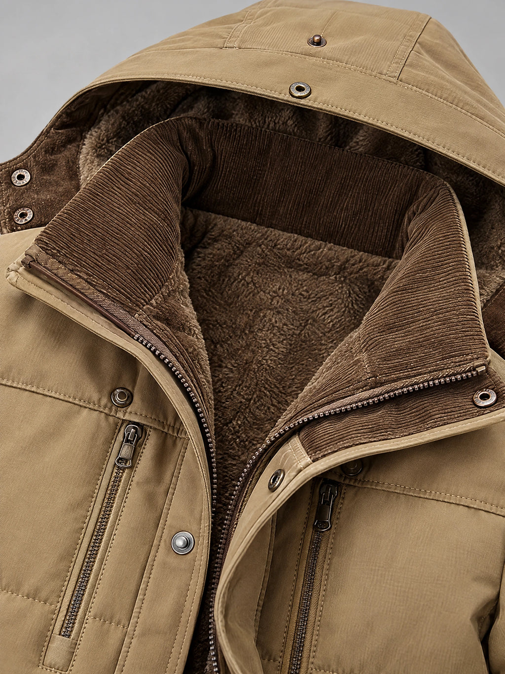 Khaki heavy winter jacket detail showing the fleece-lined collar, ribbed inner trim, snap fasteners, and zippered chest pockets.
