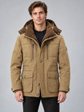 Front studio view of a model wearing a Khaki heavy winter jacket with a hood, zip chest pockets, and button-flap front pockets.
