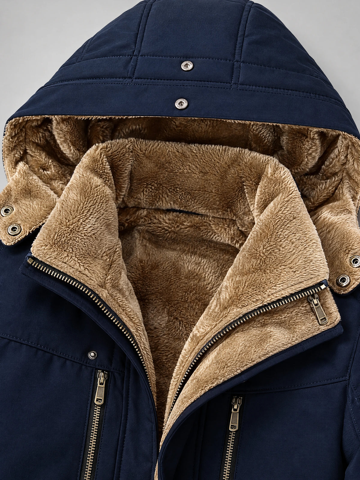 Navy men’s heavy winter jacket detail showing the plush fleece-lined hood, snap closures, and front zippers.
