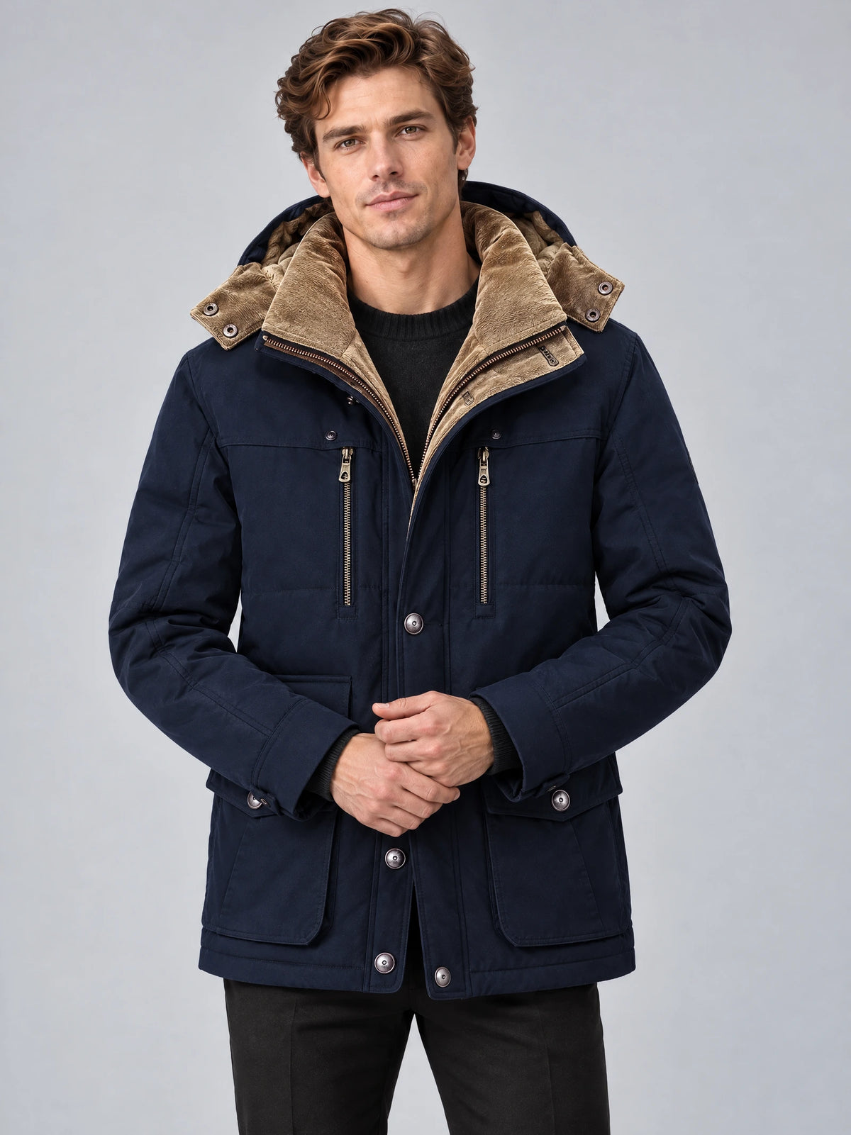 Front studio view of a model wearing a Navy Heavy Winter Jacket with fleece-lined hood, zip chest pockets, and flap pockets.