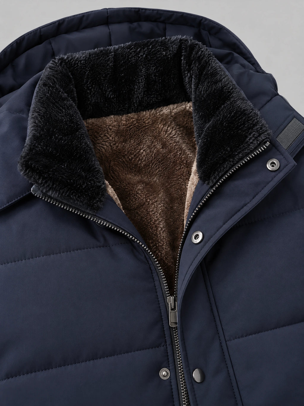 Close-up of the Navy men's heavy winter jacket showing the fleece-lined stand collar, zip front, and snap-button storm flap.