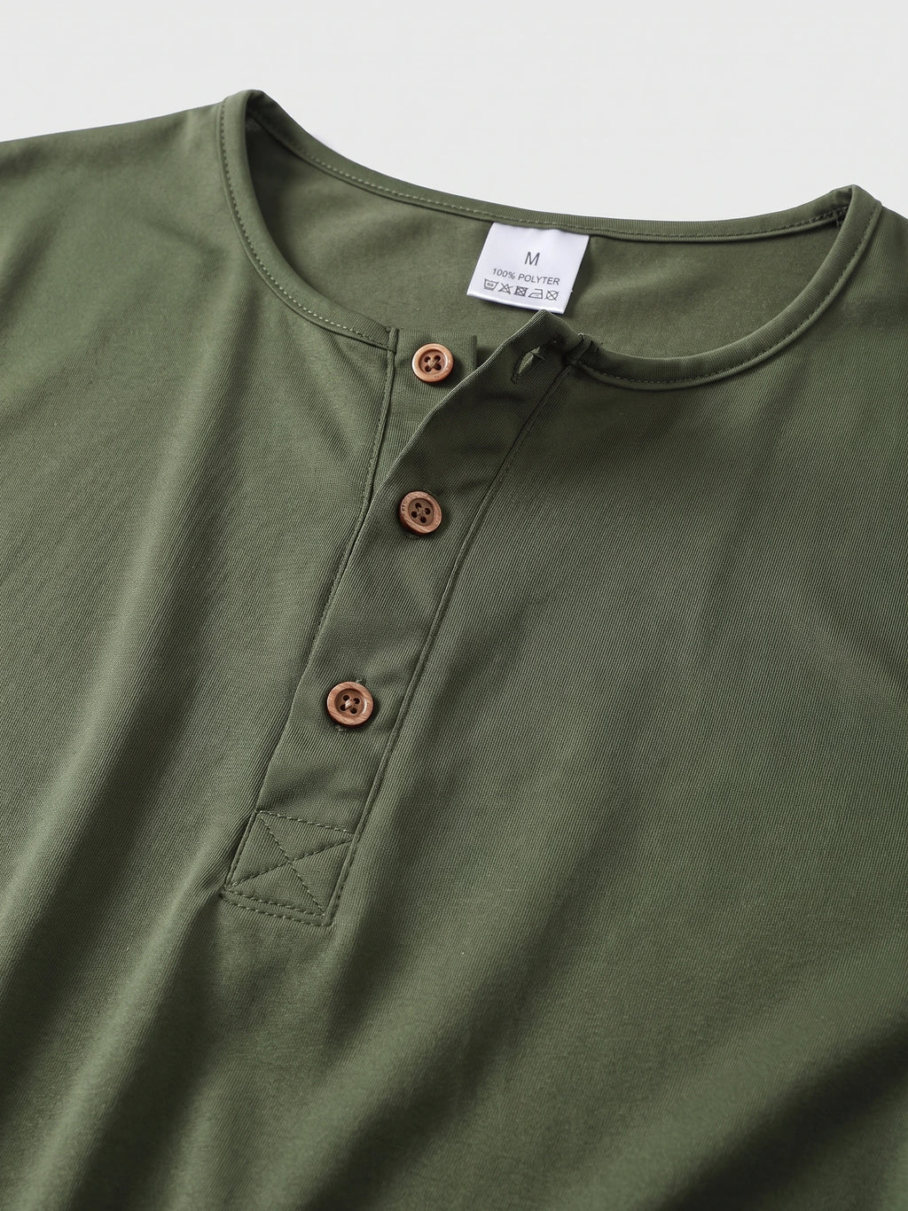 Close-up of the Green Henley T-shirt neckline with a three-button placket and reinforced stitching.