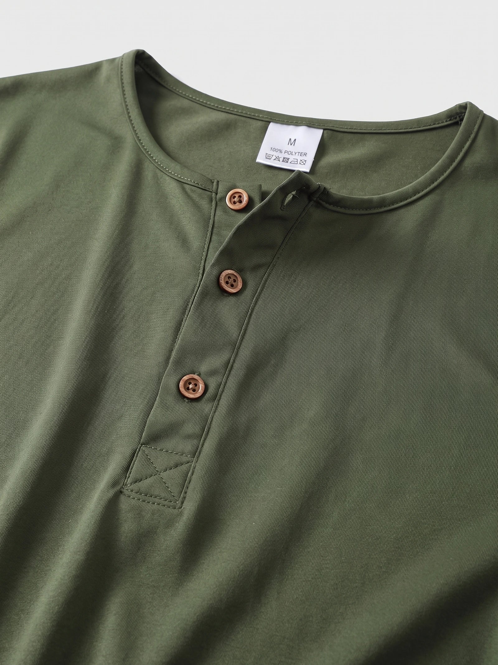 Close-up of the Green Henley T-shirt neckline with a three-button placket and reinforced stitching.