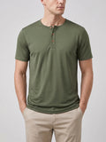 Front studio view of a model wearing a Green short-sleeve Henley T-shirt with a three-button collar.