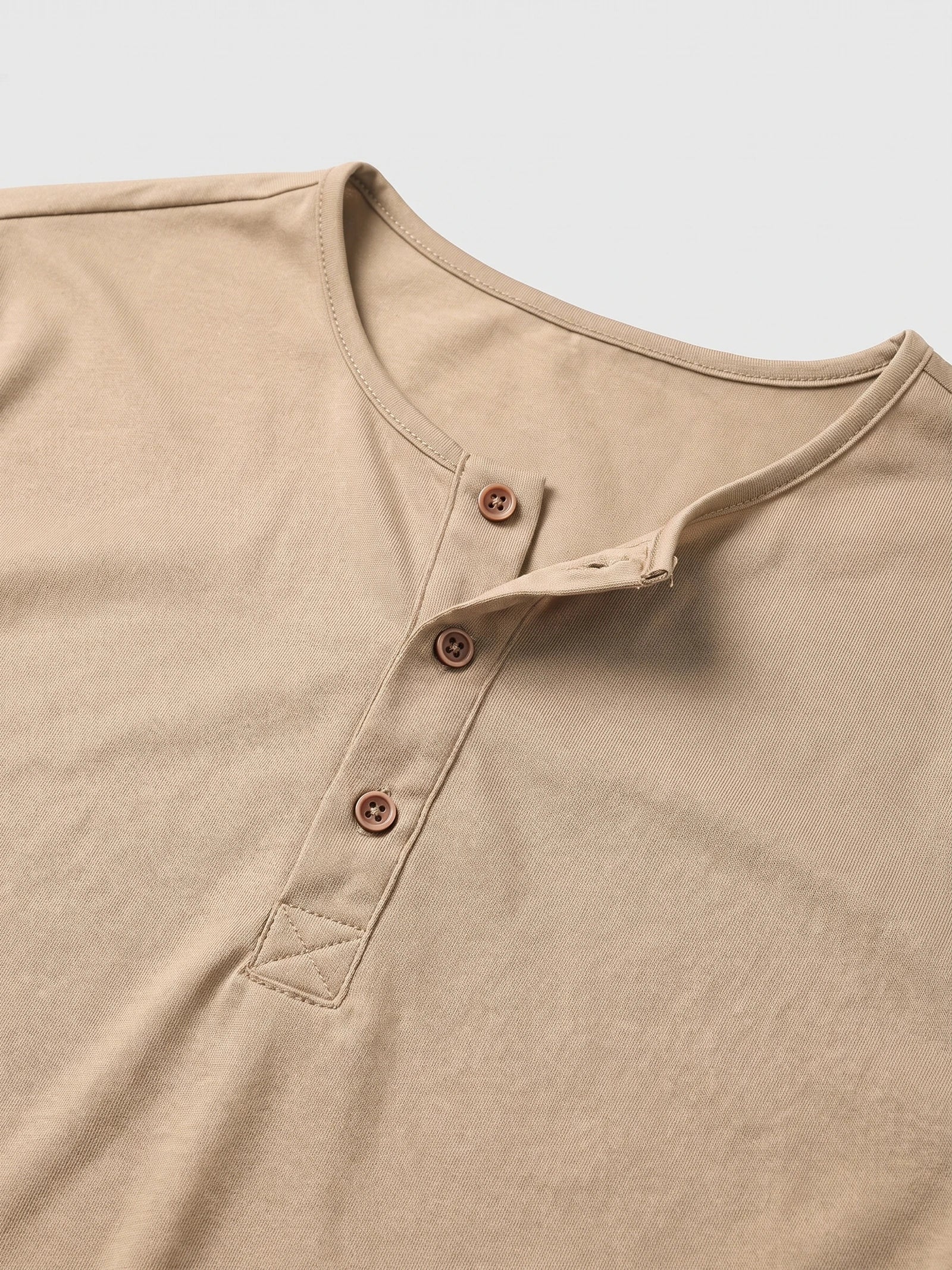 Close-up of the Khaki men's Henley T-shirt, showing the ribbed neckline and three-button placket.