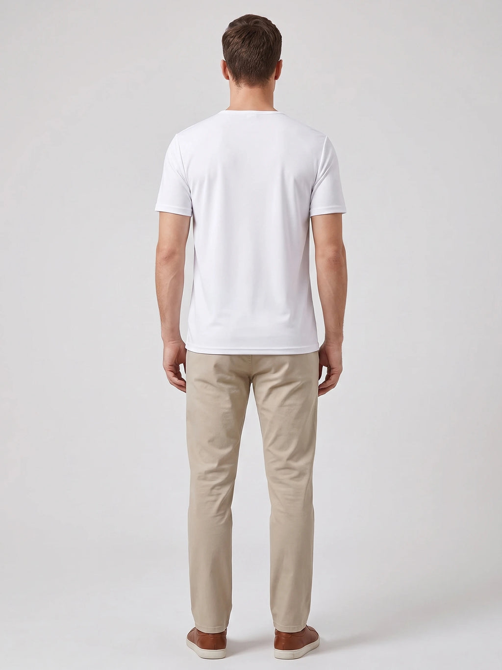 Back view of a model wearing a White short-sleeve Henley T-shirt in a studio.