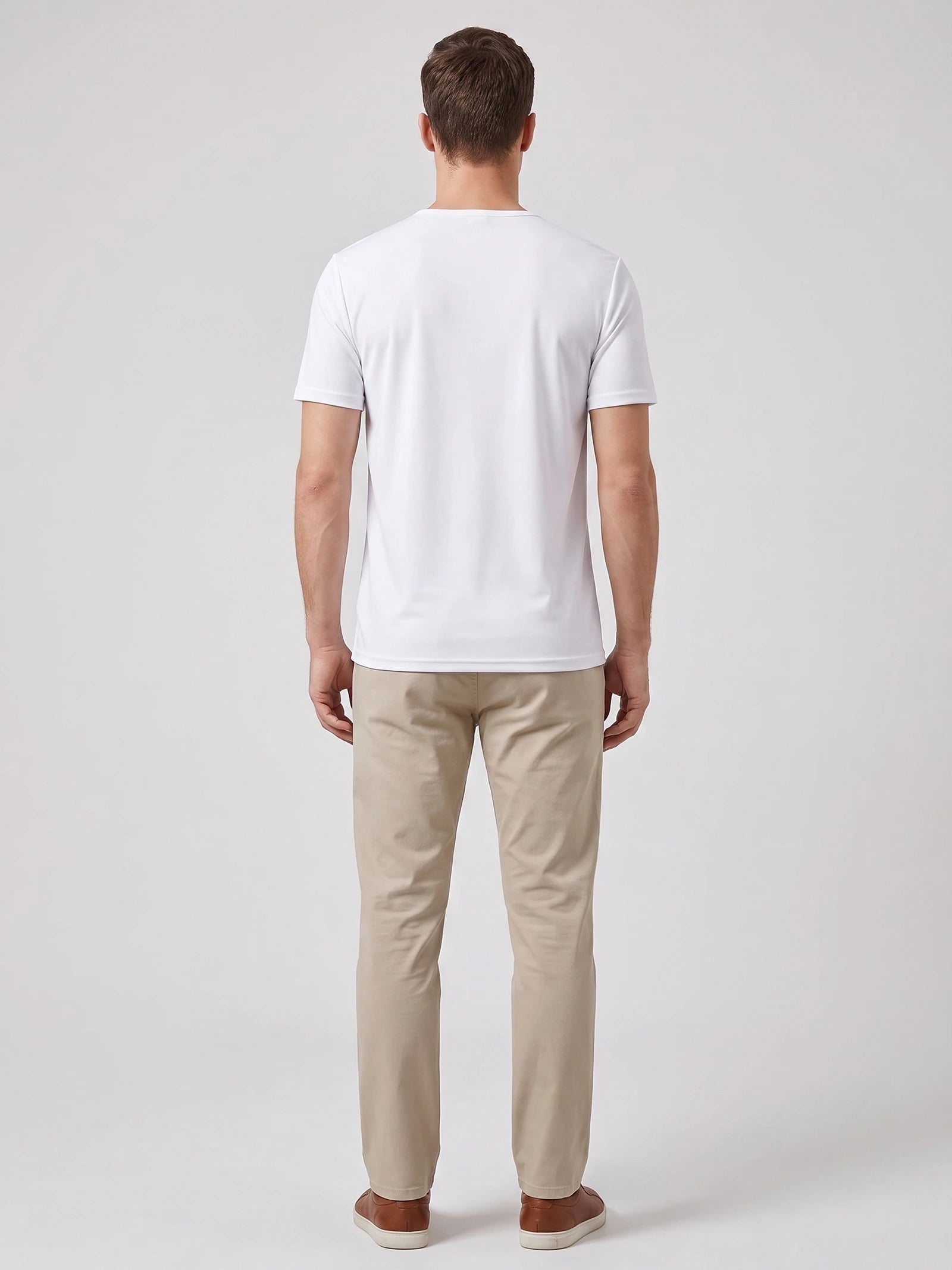 Back view of a model wearing a White short-sleeve Henley T-shirt in a studio.