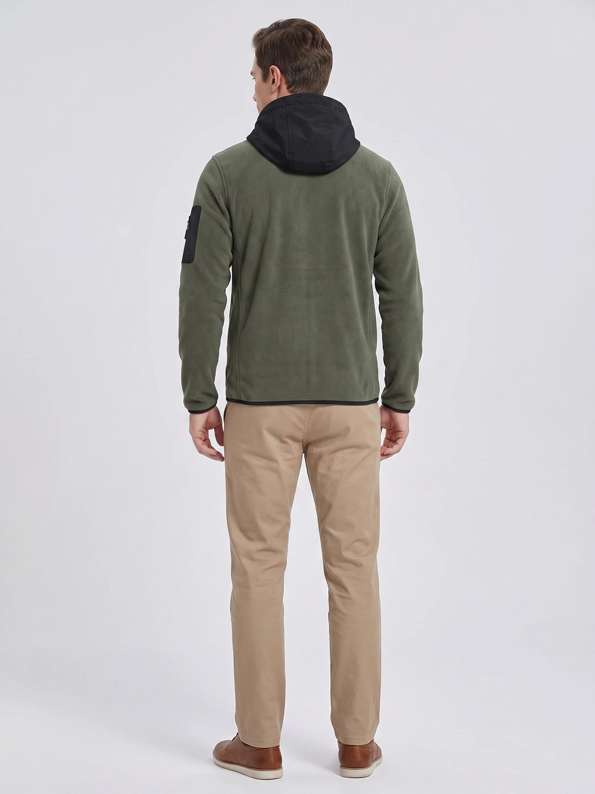 Rear studio view of a model wearing a Green fleece jacket with a hood and sleeve pocket.