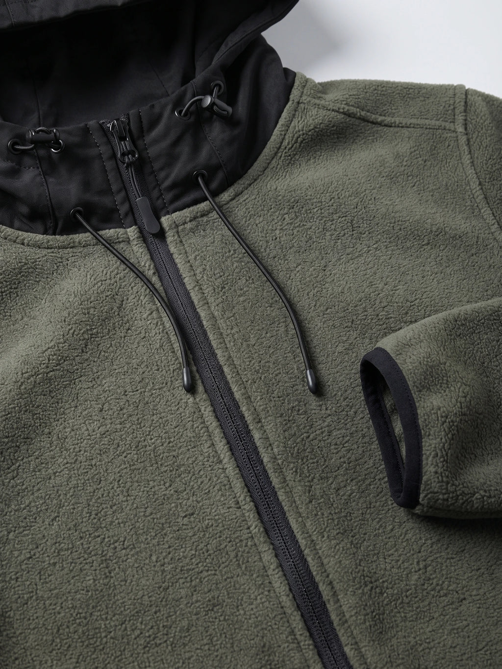 Close-up of the Green men’s Fleece Jacket showing the textured fleece, full zipper, hood lining, and adjustable drawcords.