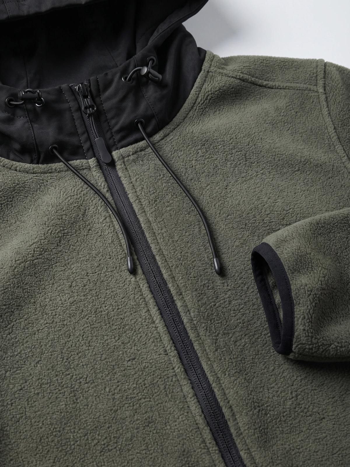 Close-up of the Green men’s Fleece Jacket showing the textured fleece, full zipper, hood lining, and adjustable drawcords.