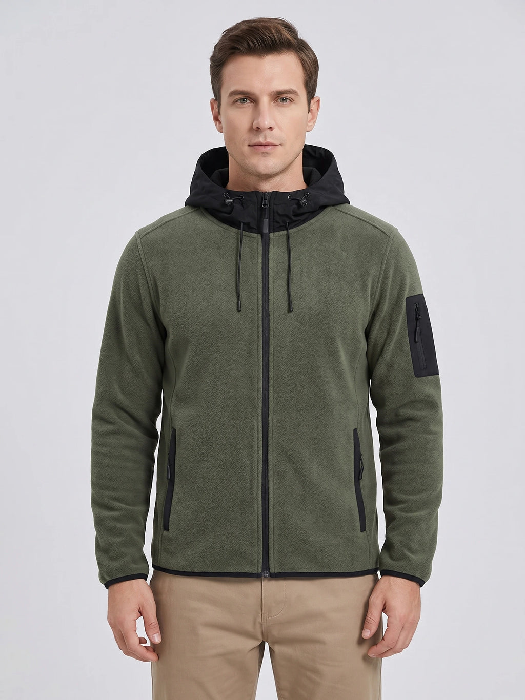 Front studio view of a model wearing a Green fleece jacket with a full zip, hood, zippered hand pockets, and sleeve pocket.