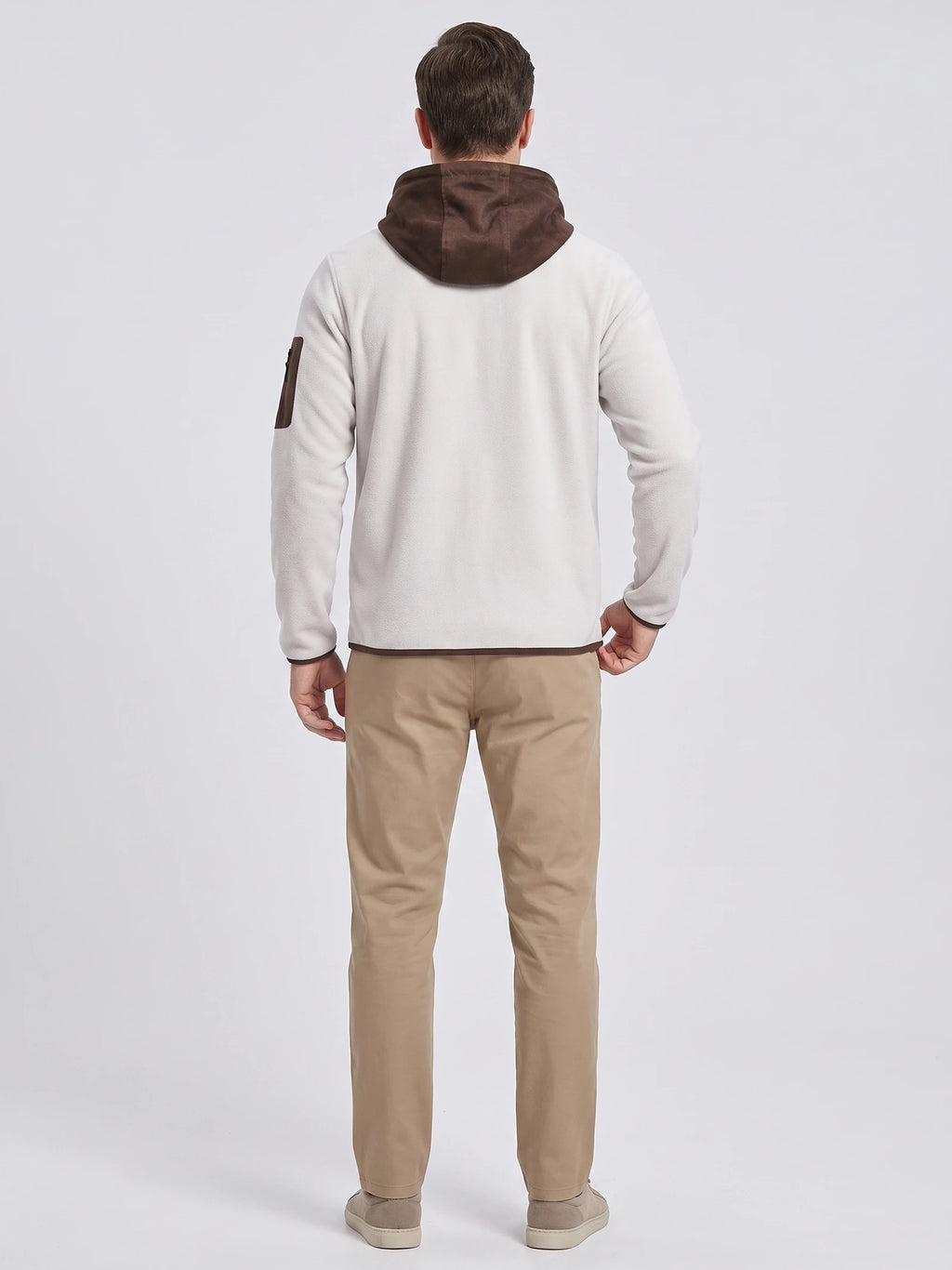 Rear studio view of a model wearing the White fleece jacket with a hood and sleeve zip pocket.