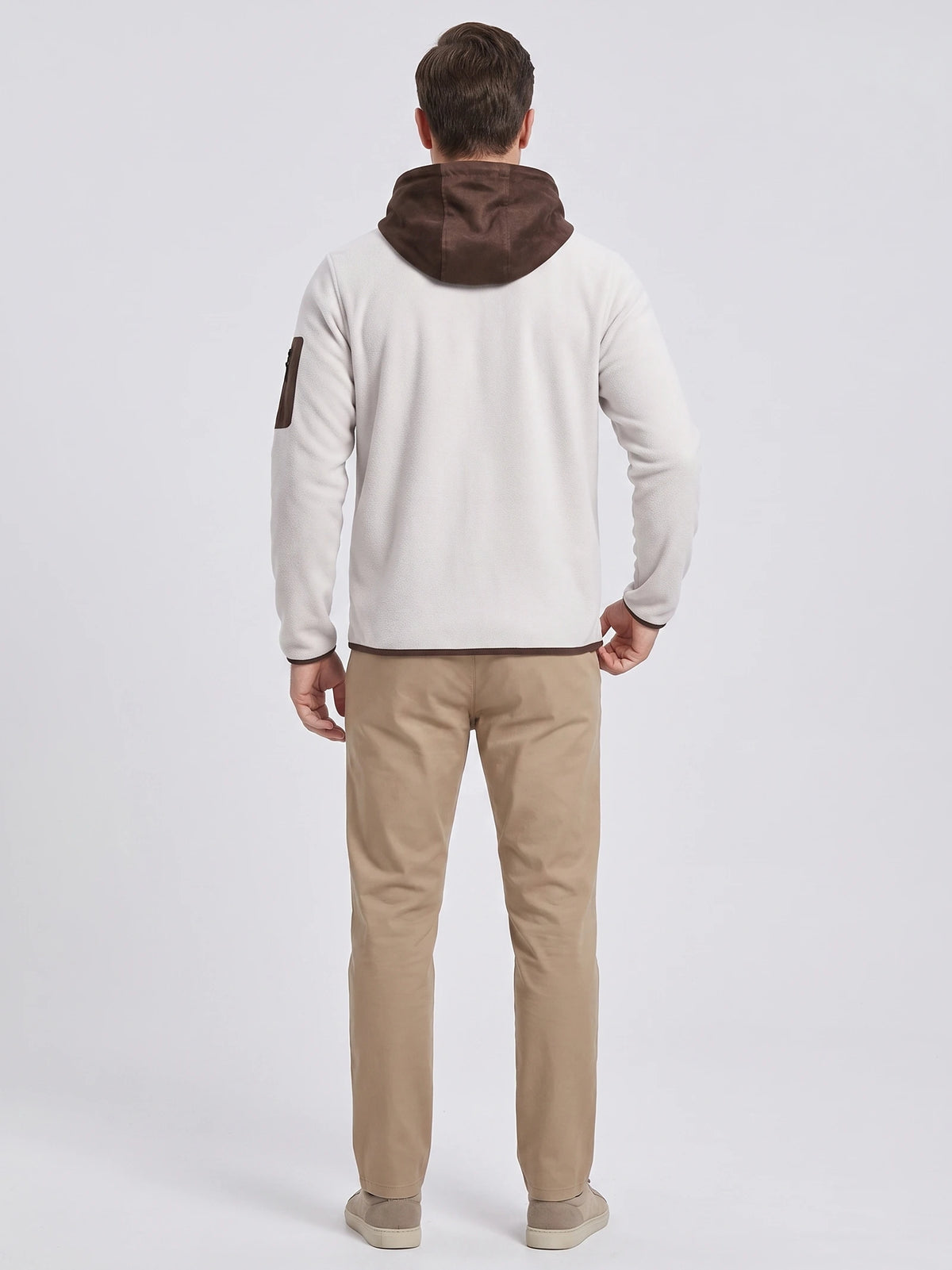 Rear studio view of a model wearing the White fleece jacket with a hood and sleeve zip pocket.