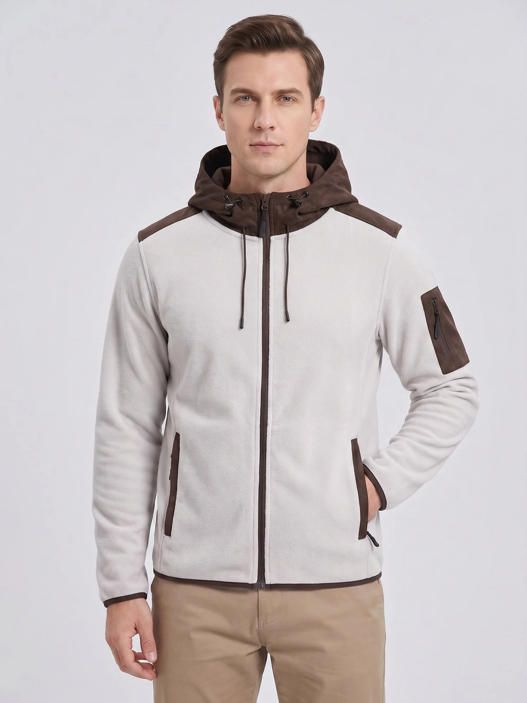 Front studio view of a model wearing a White fleece jacket with a hood, full zip, and multiple zip pockets.
