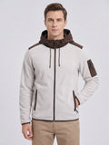 Front studio view of a model wearing a White fleece jacket with a hood, full zip, and multiple zip pockets.