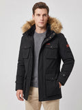 Front studio view of a model wearing a Black men's parka with a fur-trimmed hood, snap-flap pockets, and zip front.