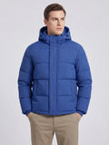 Model wearing a Blue hooded puffer jacket in a front studio view, with quilted panels, snap placket, and angled pockets.