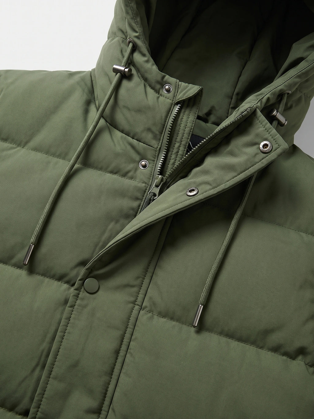 Close-up of the Green Hooded Puffer Jacket with a zip front, snap storm flap, and adjustable hood drawcords.
