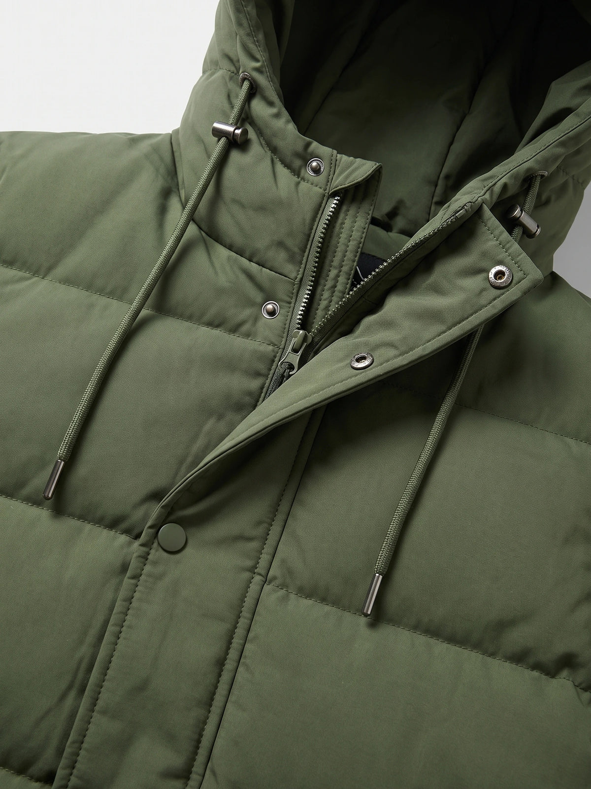 Close-up of the Green Hooded Puffer Jacket with a zip front, snap storm flap, and adjustable hood drawcords.
