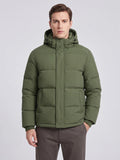 Front studio view of a model wearing a Green hooded puffer jacket with a snap-front placket and angled pockets.