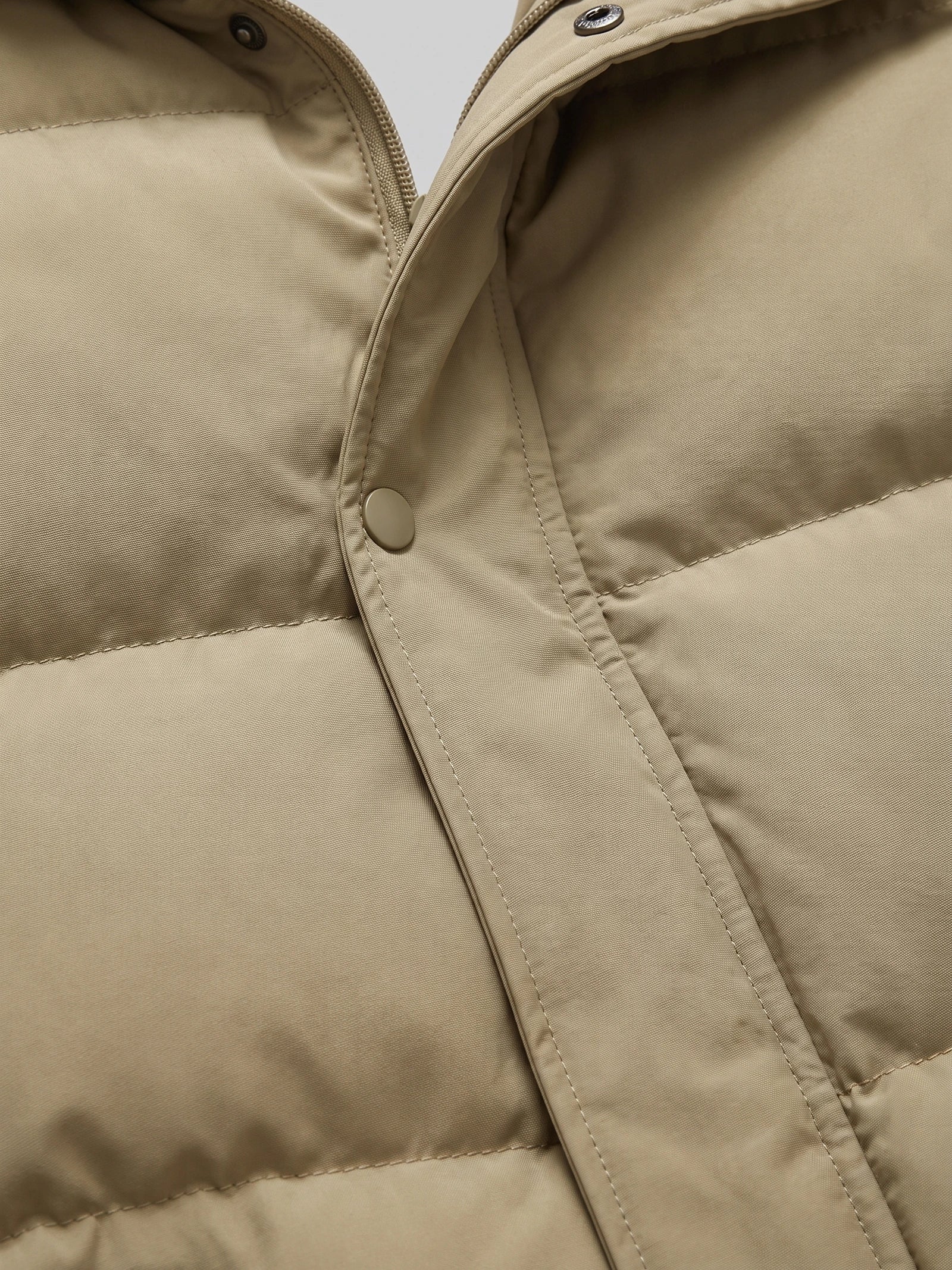 Close-up of the Khaki men's Hooded Puffer Jacket showing the front zipper, snap-button storm flap, and quilted stitching.
