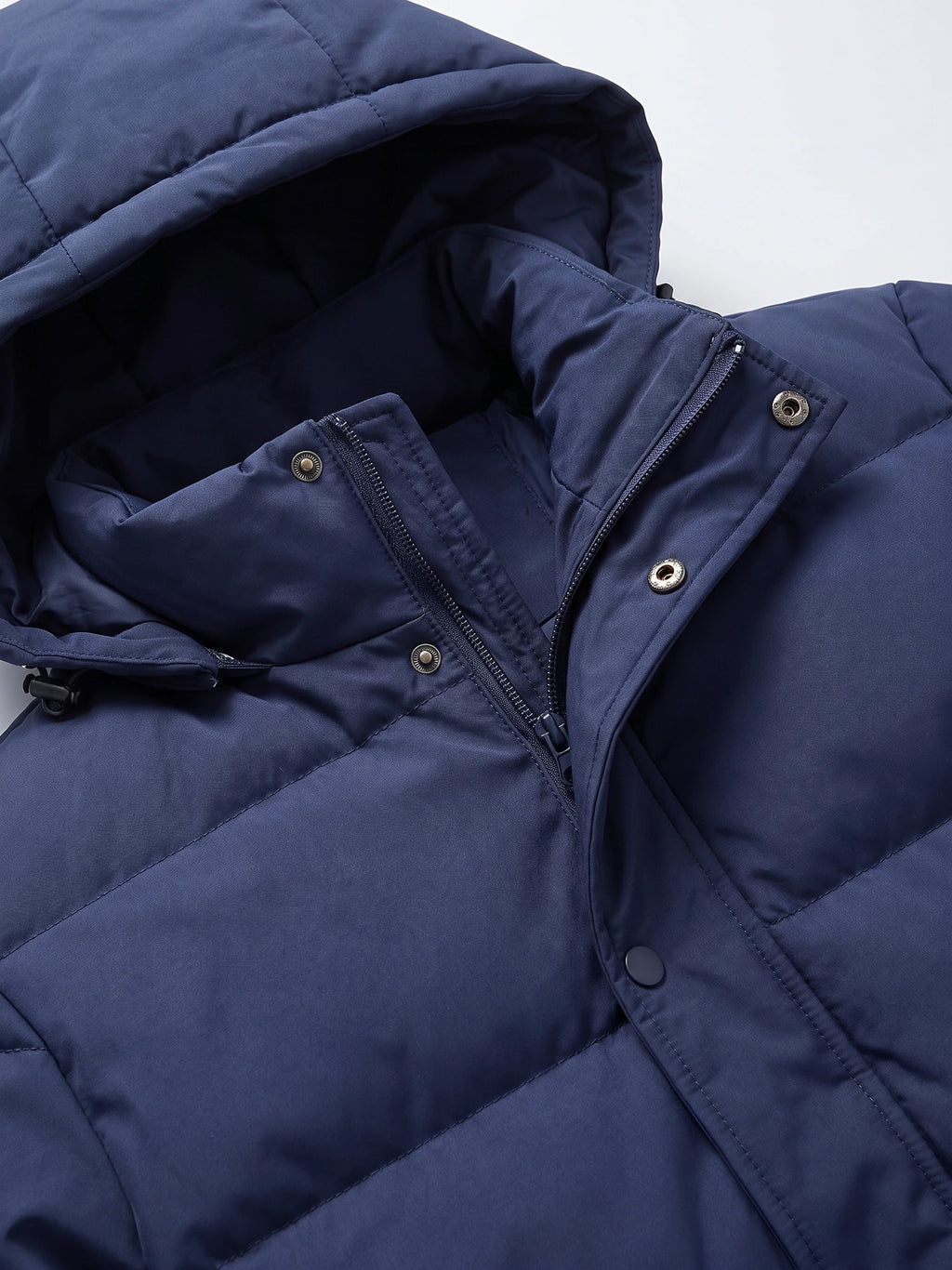 Close-up of the Navy hooded puffer jacket’s zip front, snap-button storm flap, and padded hood.
