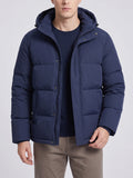 Front studio view of a model wearing a Navy hooded puffer jacket with quilted panels, zip closure, and snap-button storm flap.