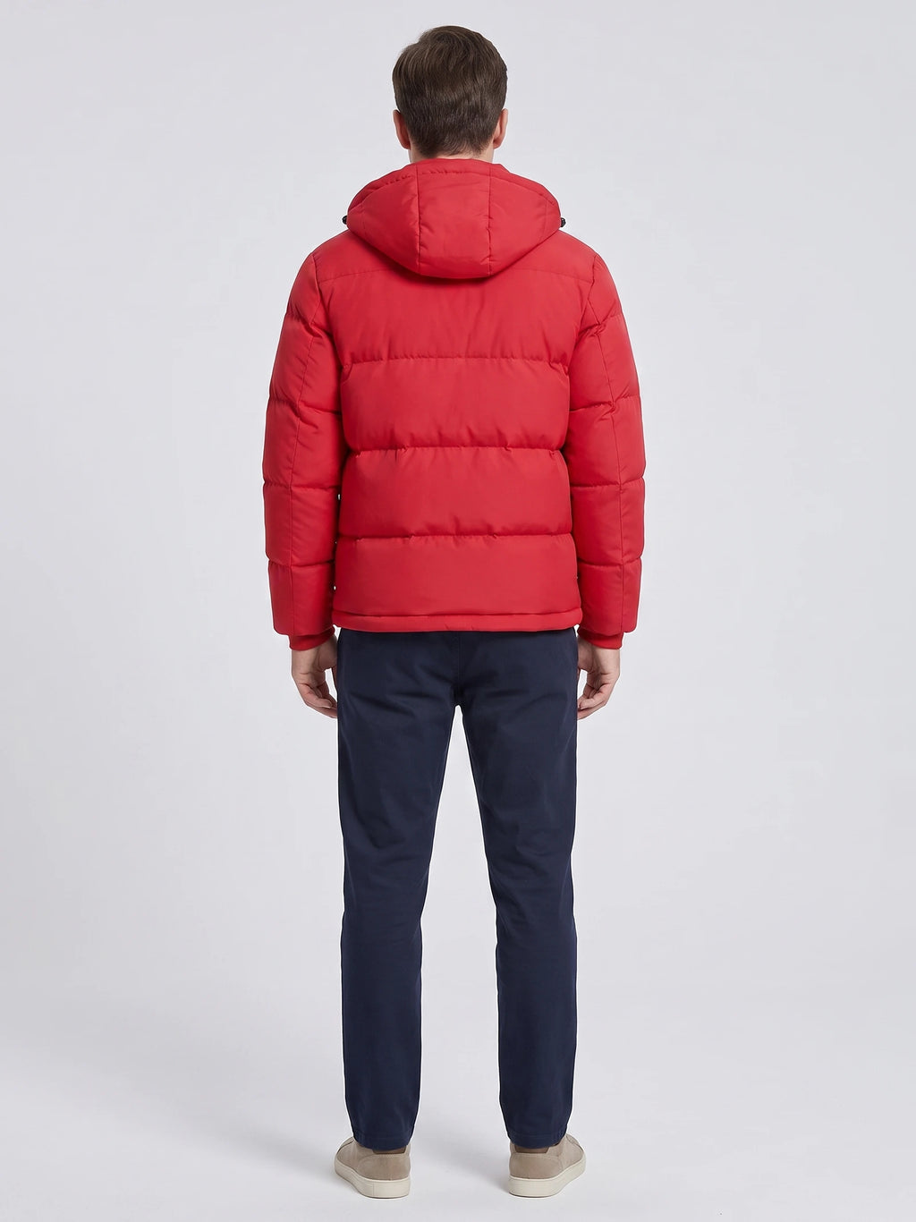 Rear studio view of a model wearing a Red hooded puffer jacket with horizontal quilted panels.