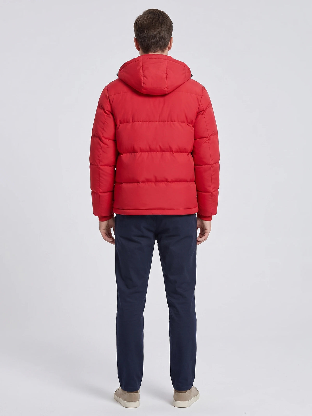 Rear studio view of a model wearing a Red hooded puffer jacket with horizontal quilted panels.