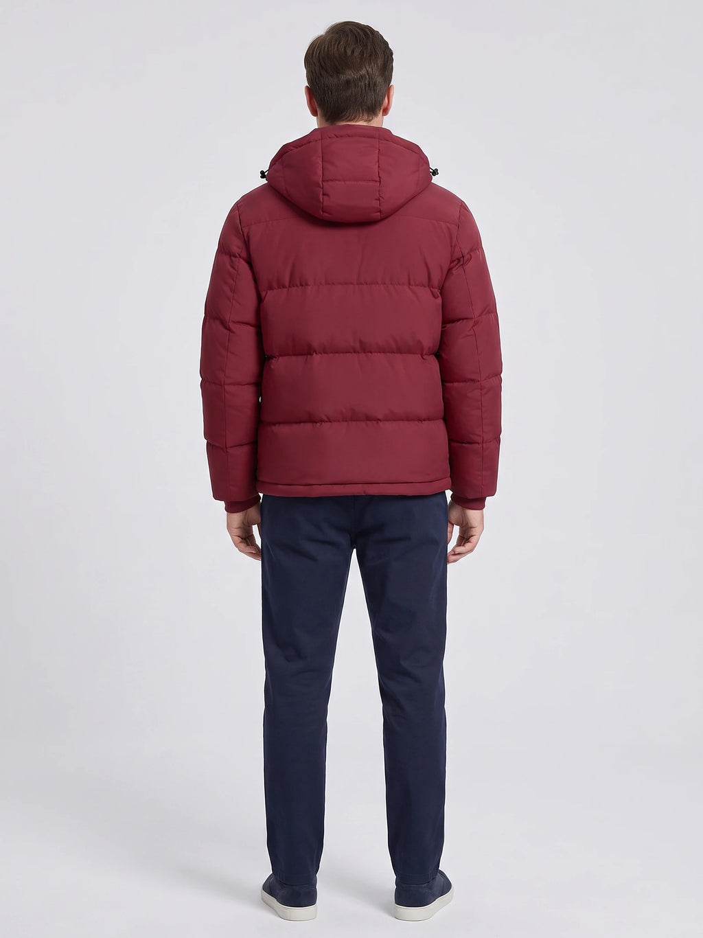 Rear view of a model wearing a Wine hooded puffer jacket with horizontal quilted panels.
