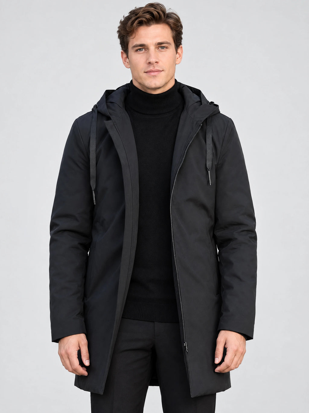 Front studio view of a model wearing a Black Men’s Hooded Trench Coat with an open zip front and adjustable hood drawstrings.