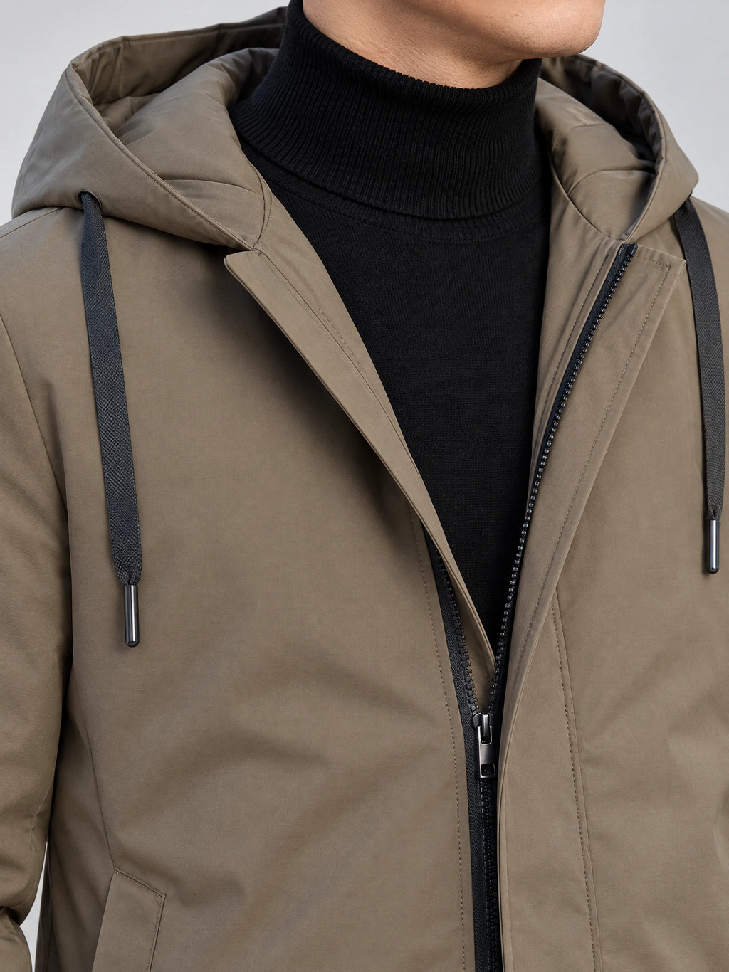 Close-up of a Brown men’s hooded trench coat showing the padded hood, drawstrings, and front zipper.